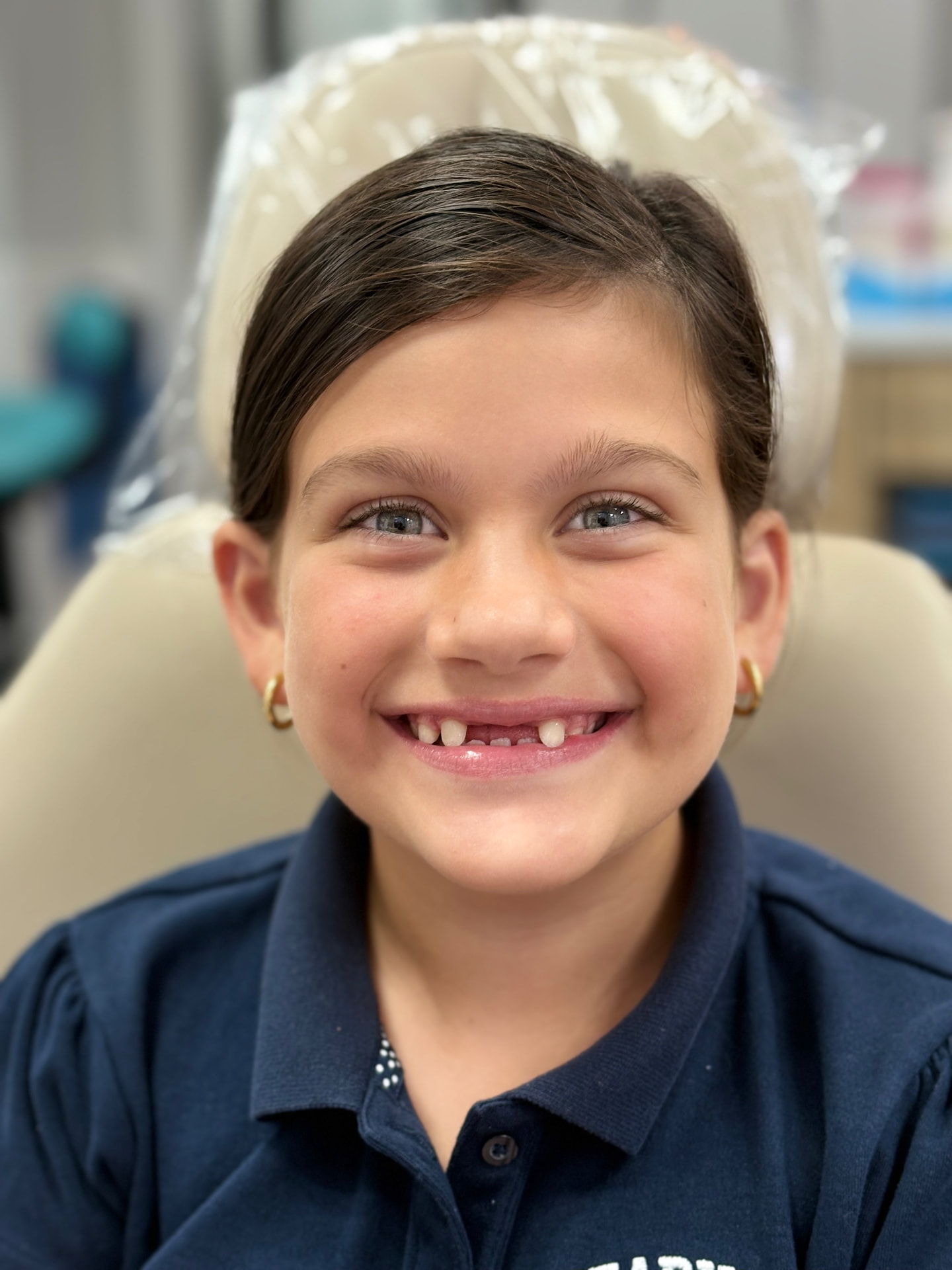 Child orthodontic patient smiling in a treatment chair