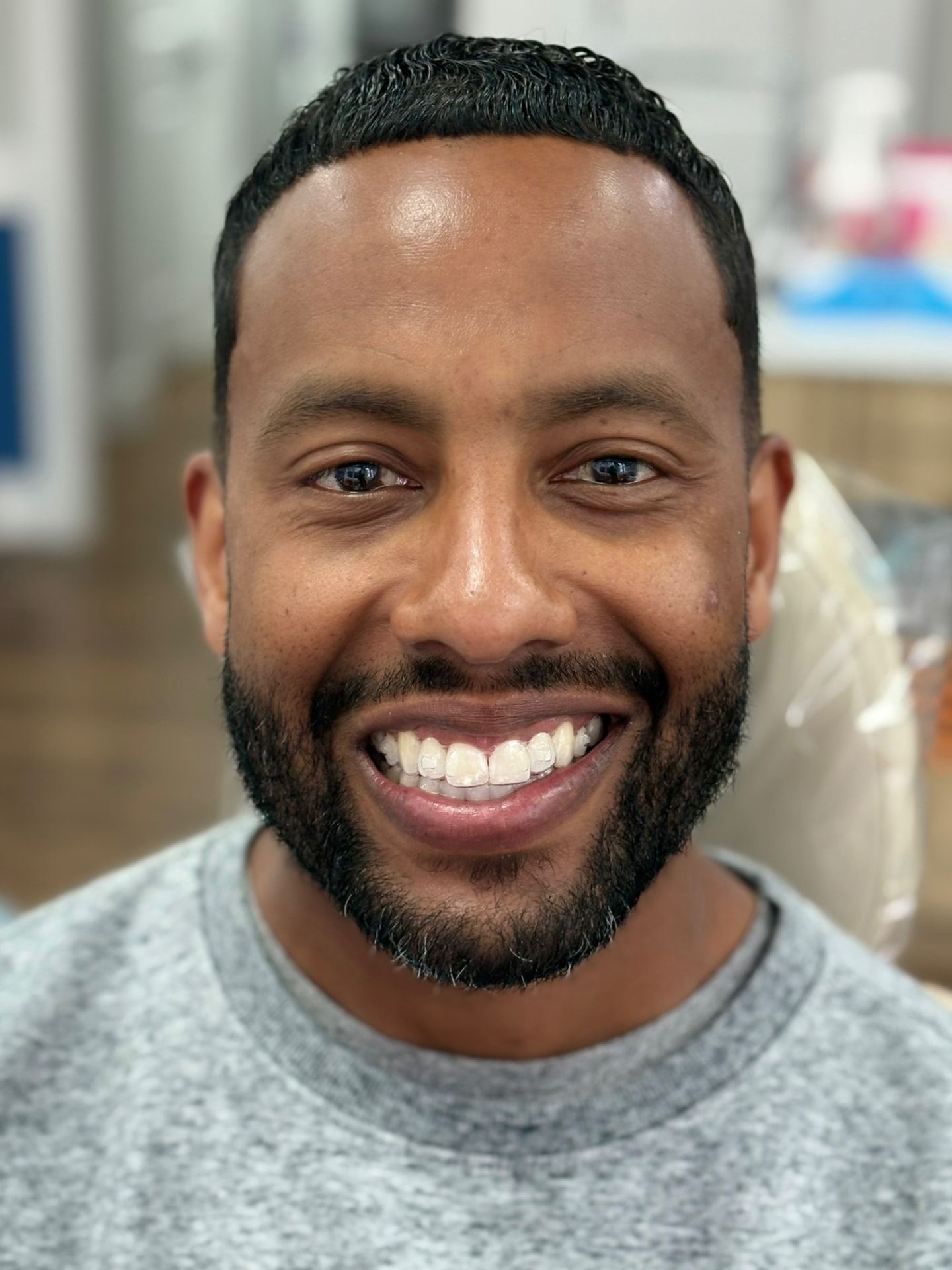 Adult orthodontic patient smiling in a treatment chair